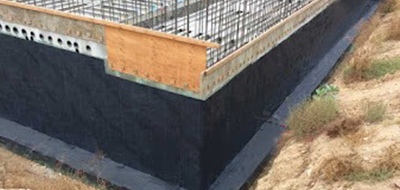 Construction worker using trowel to smooth floor