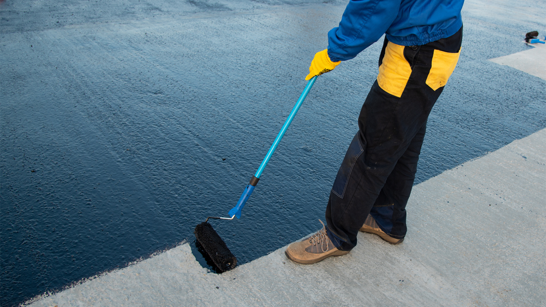 Person using trowel to spread self-leveling compound